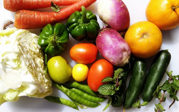 A collection of brightly colored vegetables on a white table