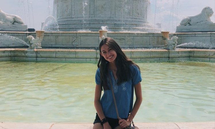 Sabrina poses in front of a fountain