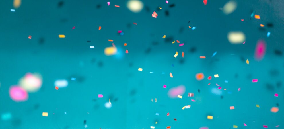 confetti floats across a blue screen